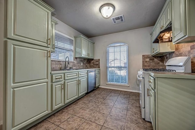 kitchen with gas range gas stove, sink, tasteful backsplash, stainless steel dishwasher, and exhaust hood