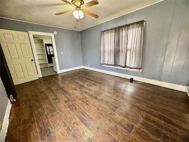 unfurnished bedroom featuring ceiling fan, wood-type flooring, and a closet