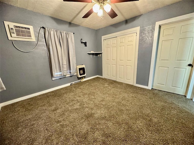 unfurnished bedroom with ceiling fan, carpet floors, and heating unit