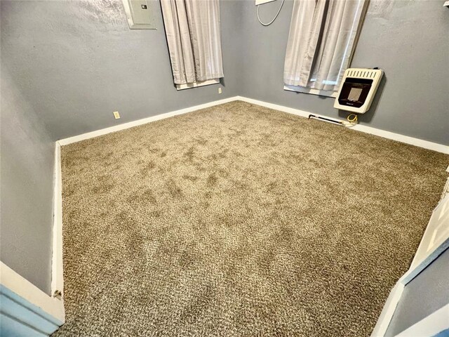 carpeted spare room with heating unit