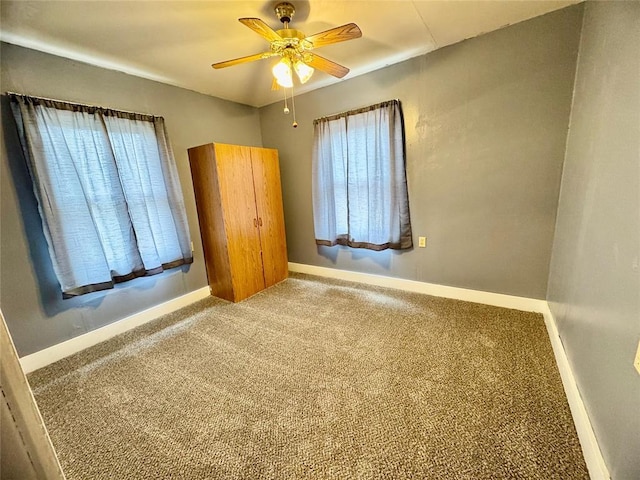 unfurnished bedroom with ceiling fan and carpet flooring