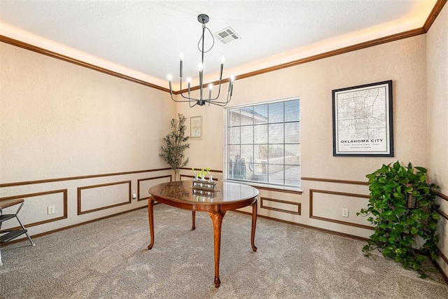 carpeted dining area featuring crown molding, a textured ceiling, and a notable chandelier