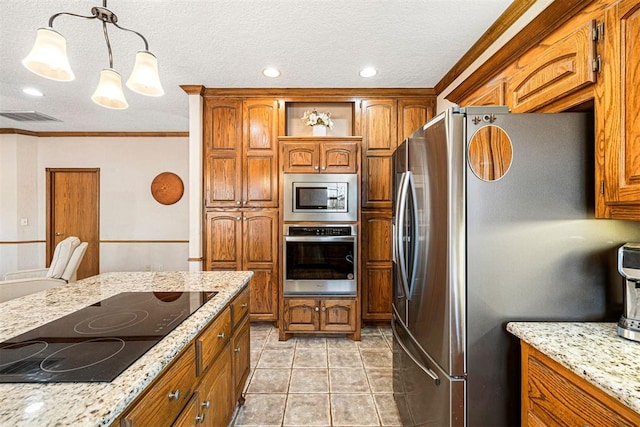 kitchen with hanging light fixtures, crown molding, light tile patterned floors, appliances with stainless steel finishes, and light stone counters