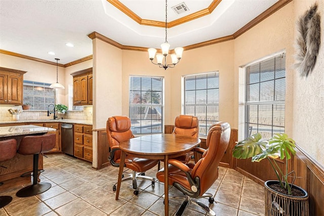 tiled dining room with crown molding, sink, and a notable chandelier