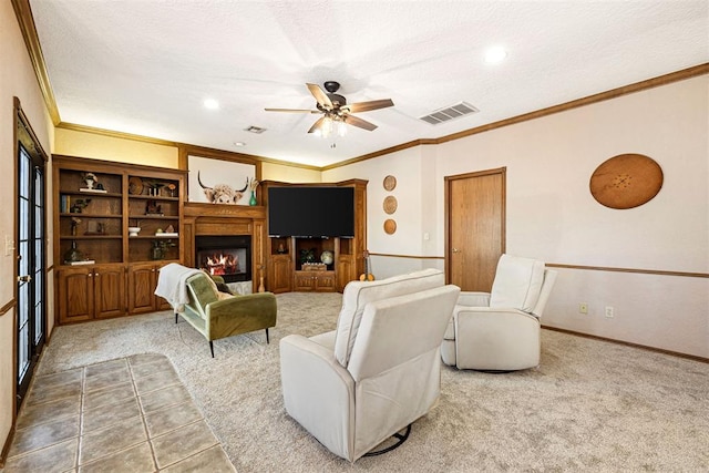 living room with carpet flooring, a textured ceiling, ceiling fan, and ornamental molding