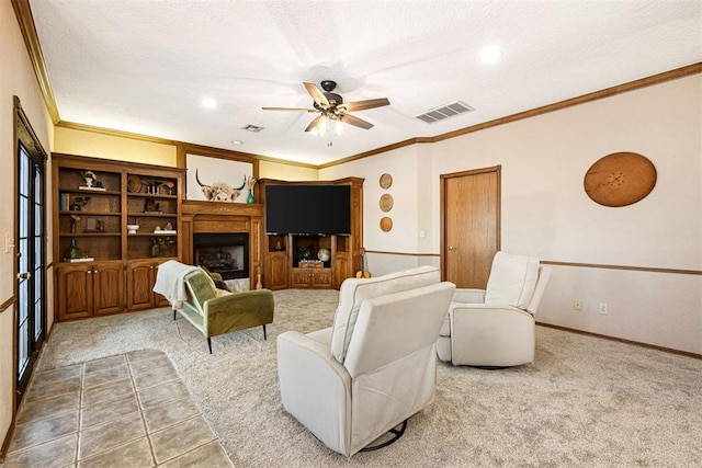 carpeted living room featuring ceiling fan, a textured ceiling, and ornamental molding