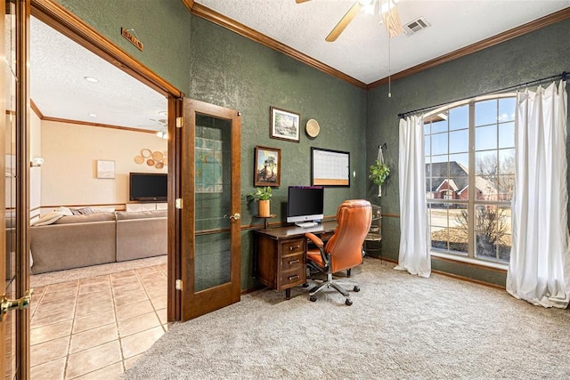 home office with french doors, ornamental molding, a textured ceiling, ceiling fan, and carpet floors