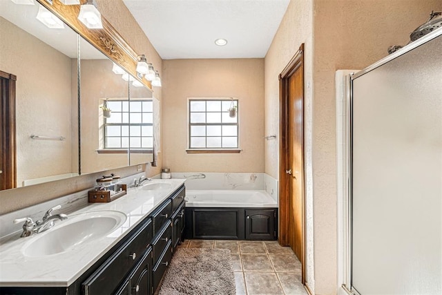 bathroom featuring tile patterned floors, vanity, and plus walk in shower