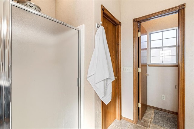 bathroom featuring tile patterned flooring and walk in shower