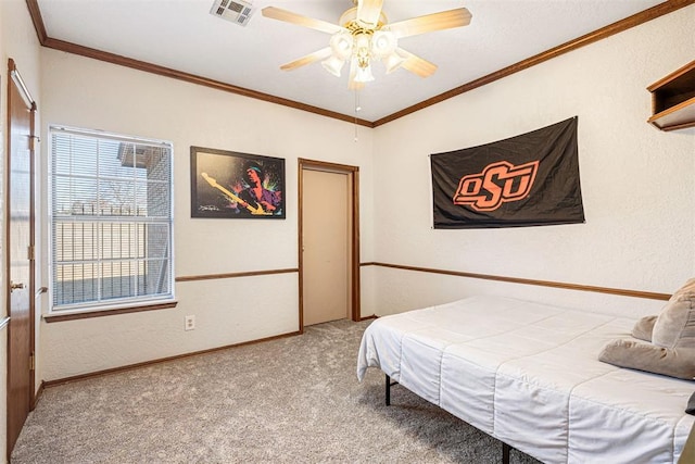 bedroom with ceiling fan, carpet floors, and ornamental molding