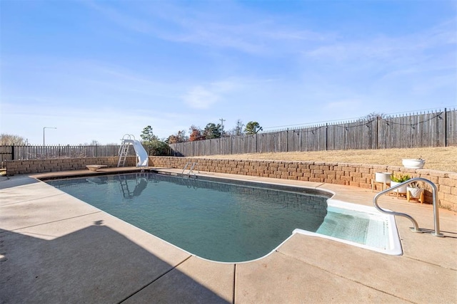 view of pool featuring a patio area and a water slide