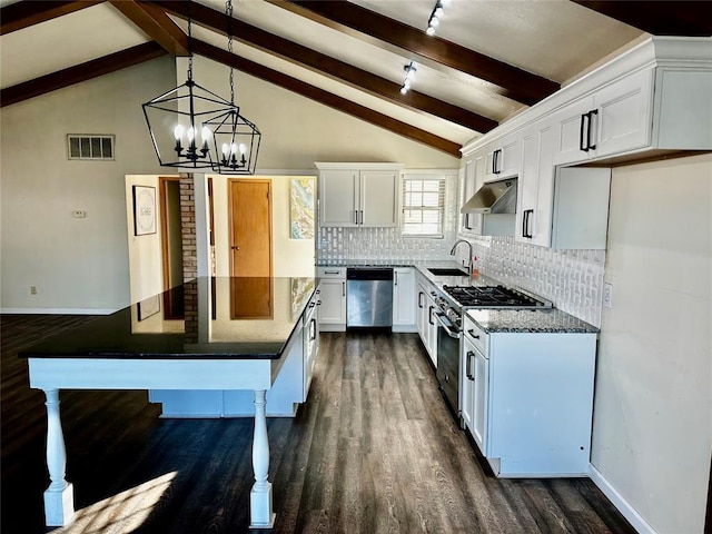 kitchen with pendant lighting, decorative backsplash, beam ceiling, white cabinetry, and stainless steel appliances