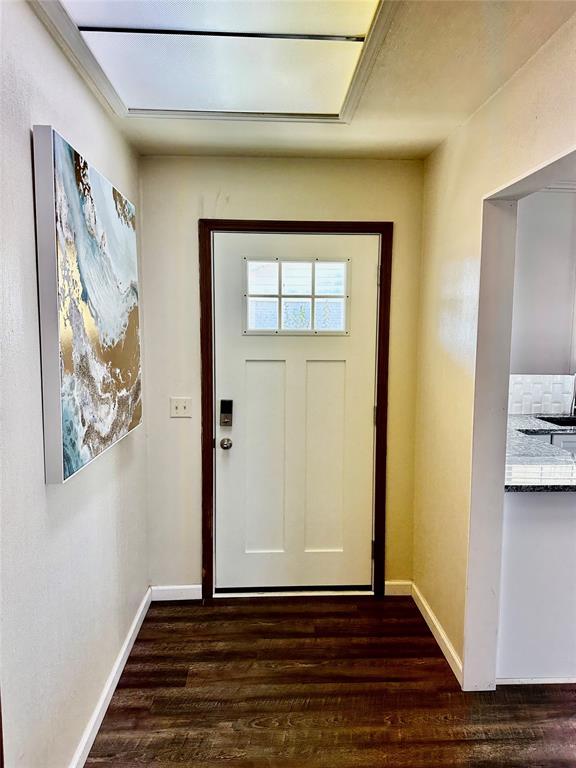 doorway to outside with dark wood-type flooring