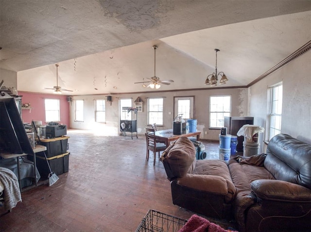 living room with hardwood / wood-style floors, ceiling fan with notable chandelier, and vaulted ceiling