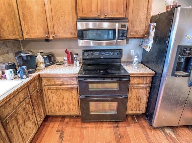 kitchen featuring backsplash, dark hardwood / wood-style flooring, stainless steel appliances, and sink