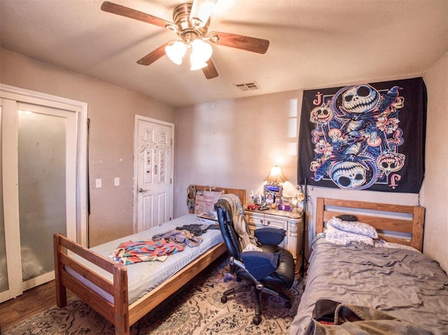 bedroom with hardwood / wood-style flooring and ceiling fan