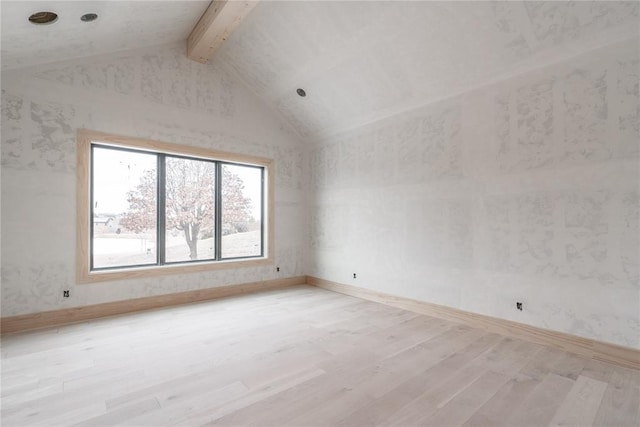 empty room with light hardwood / wood-style floors, beam ceiling, and high vaulted ceiling