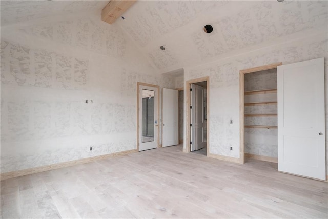 unfurnished bedroom featuring light hardwood / wood-style floors, high vaulted ceiling, and beamed ceiling