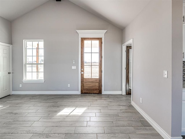 foyer with vaulted ceiling and a healthy amount of sunlight