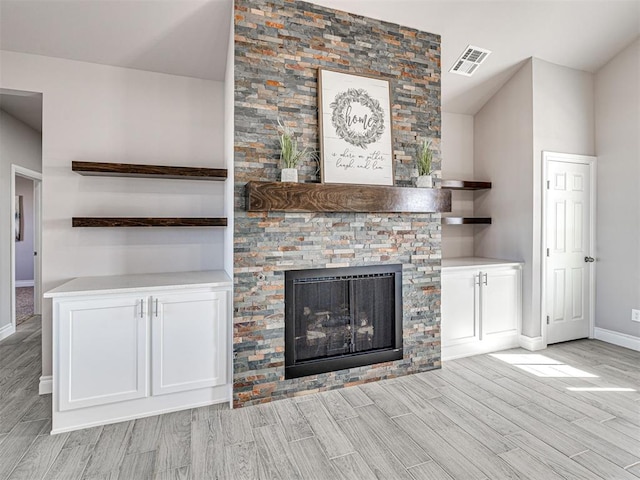 unfurnished living room with a stone fireplace