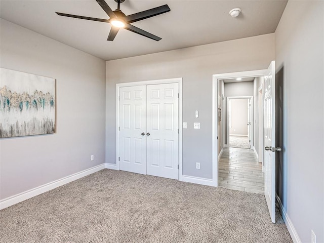 unfurnished bedroom with carpet floors, a closet, and ceiling fan