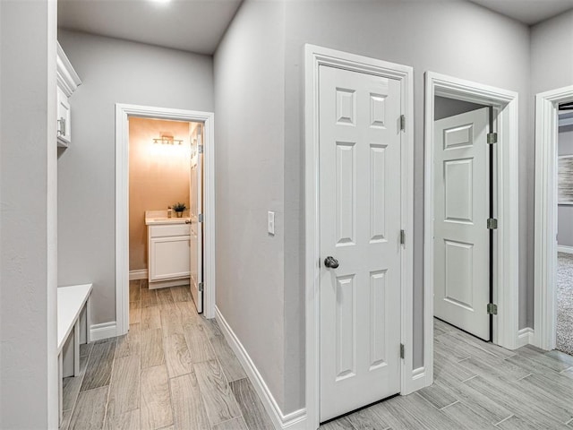 corridor with light hardwood / wood-style floors