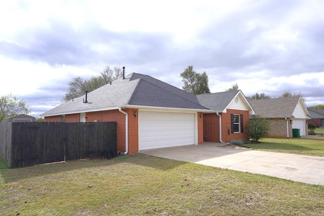 single story home with a garage and a front lawn