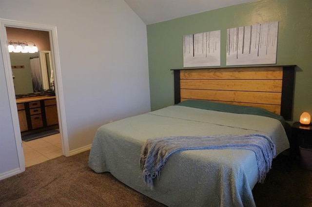 bedroom with carpet flooring and connected bathroom