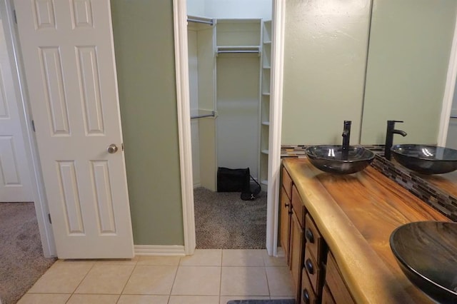 bathroom with tile patterned flooring and vanity