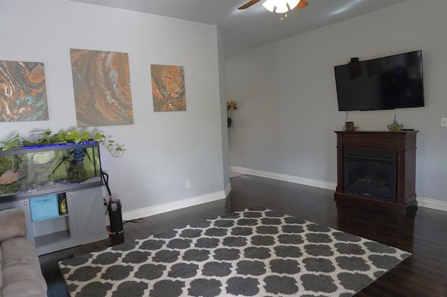 living room featuring dark hardwood / wood-style floors and ceiling fan