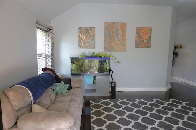 living room with dark wood-type flooring and vaulted ceiling