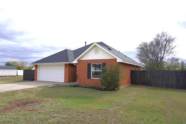 single story home with a garage and a front lawn