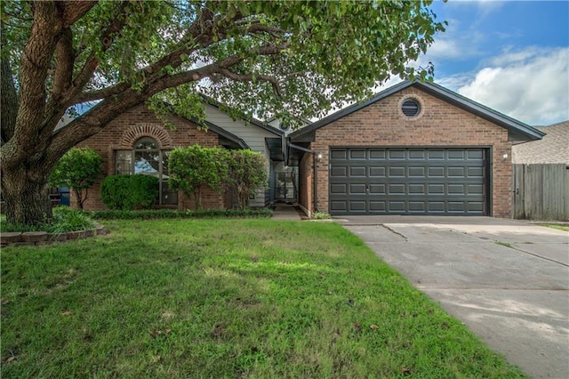 view of front of house with a front yard and a garage