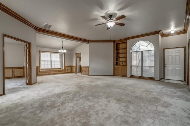 unfurnished living room with lofted ceiling, crown molding, light colored carpet, and ceiling fan with notable chandelier