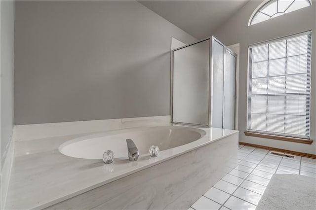 bathroom with tile patterned floors, independent shower and bath, and lofted ceiling