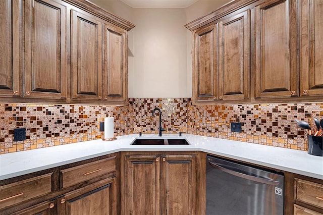 kitchen with dishwasher, sink, and tasteful backsplash