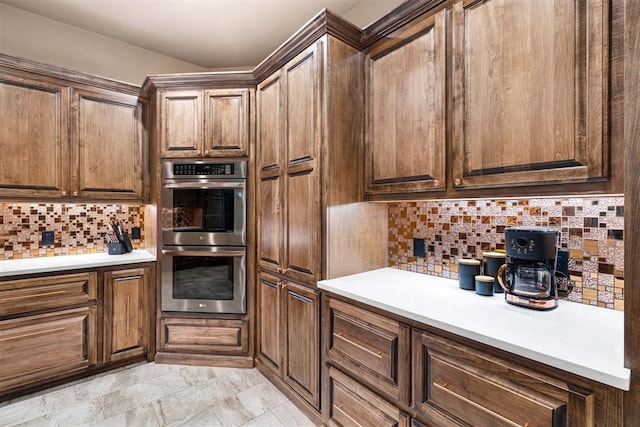 kitchen featuring decorative backsplash and double oven