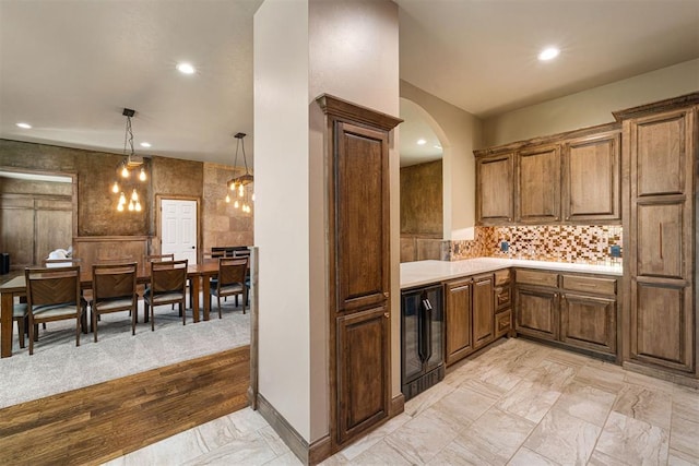 kitchen with decorative backsplash, beverage cooler, and decorative light fixtures