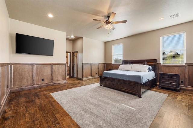 bedroom featuring multiple windows, ceiling fan, and dark hardwood / wood-style flooring