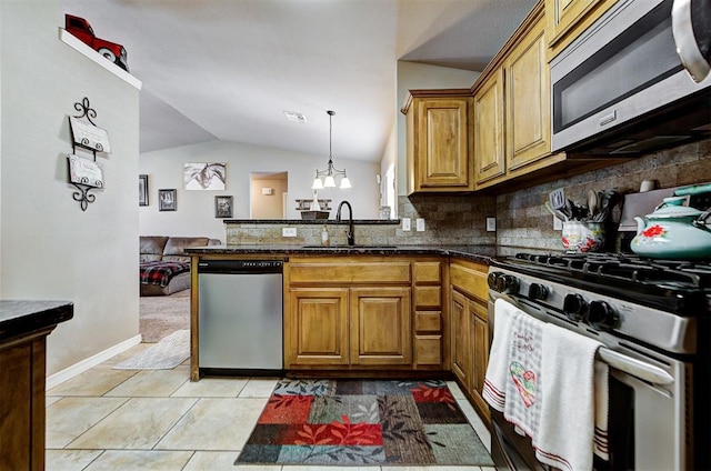 kitchen with lofted ceiling, sink, light tile patterned floors, kitchen peninsula, and stainless steel appliances