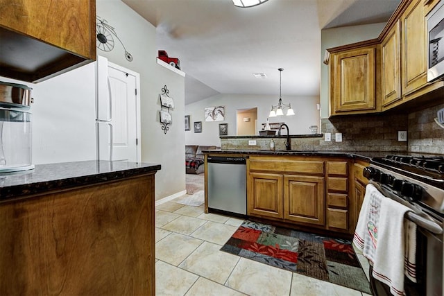 kitchen featuring decorative backsplash, appliances with stainless steel finishes, sink, light tile patterned floors, and lofted ceiling