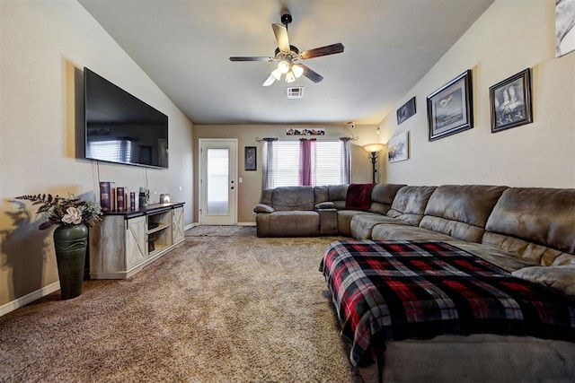 living room featuring ceiling fan, carpet floors, and vaulted ceiling