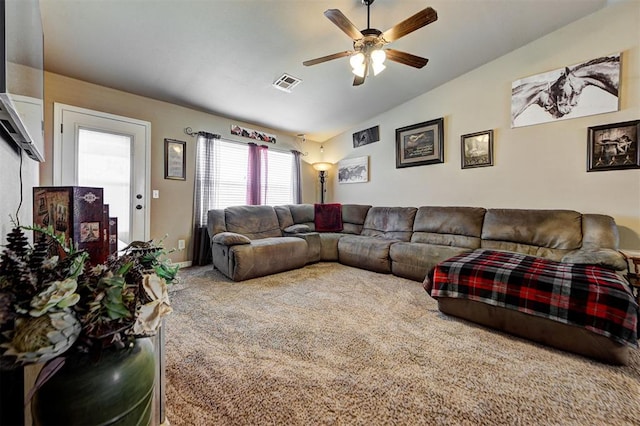 carpeted living room featuring ceiling fan and vaulted ceiling