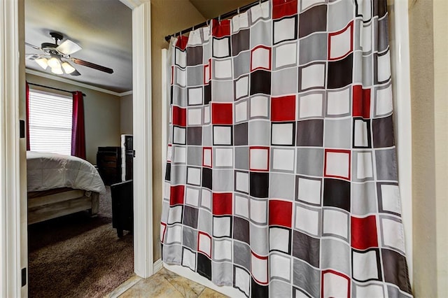 bathroom with ceiling fan and ornamental molding