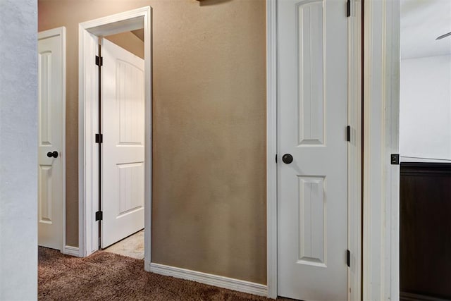 hallway with light colored carpet