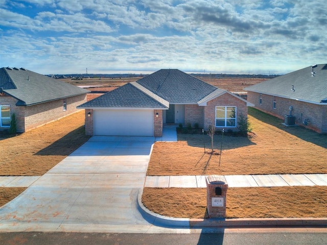 view of front facade featuring a garage and cooling unit