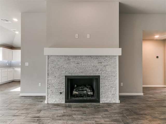 room details featuring tasteful backsplash, a fireplace, and hardwood / wood-style floors