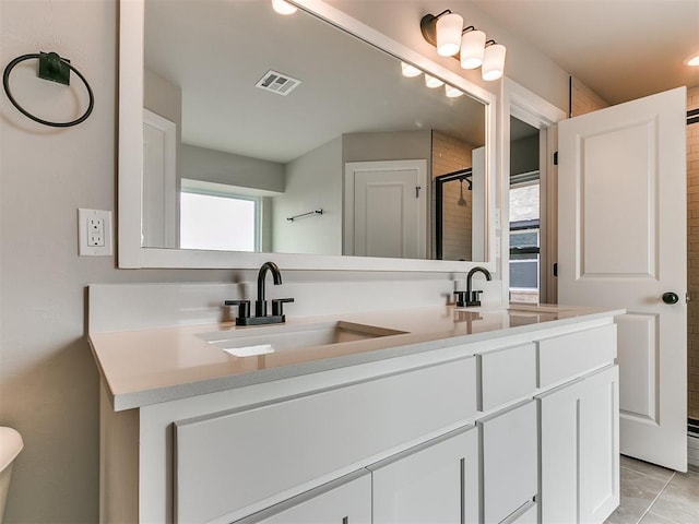 bathroom featuring vanity, tile patterned floors, and an enclosed shower