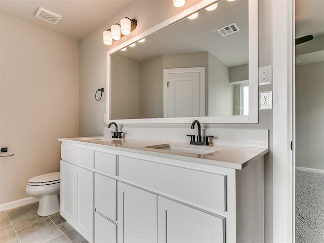 bathroom with tile patterned floors, vanity, and toilet