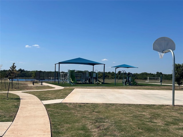 surrounding community featuring a playground, a yard, and basketball court